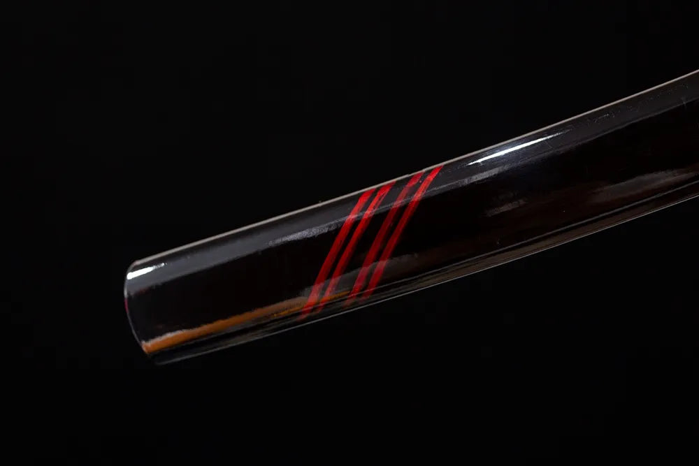 Bottom high‑gloss‑black saya black‑iron kojiri end‑cap close‑up