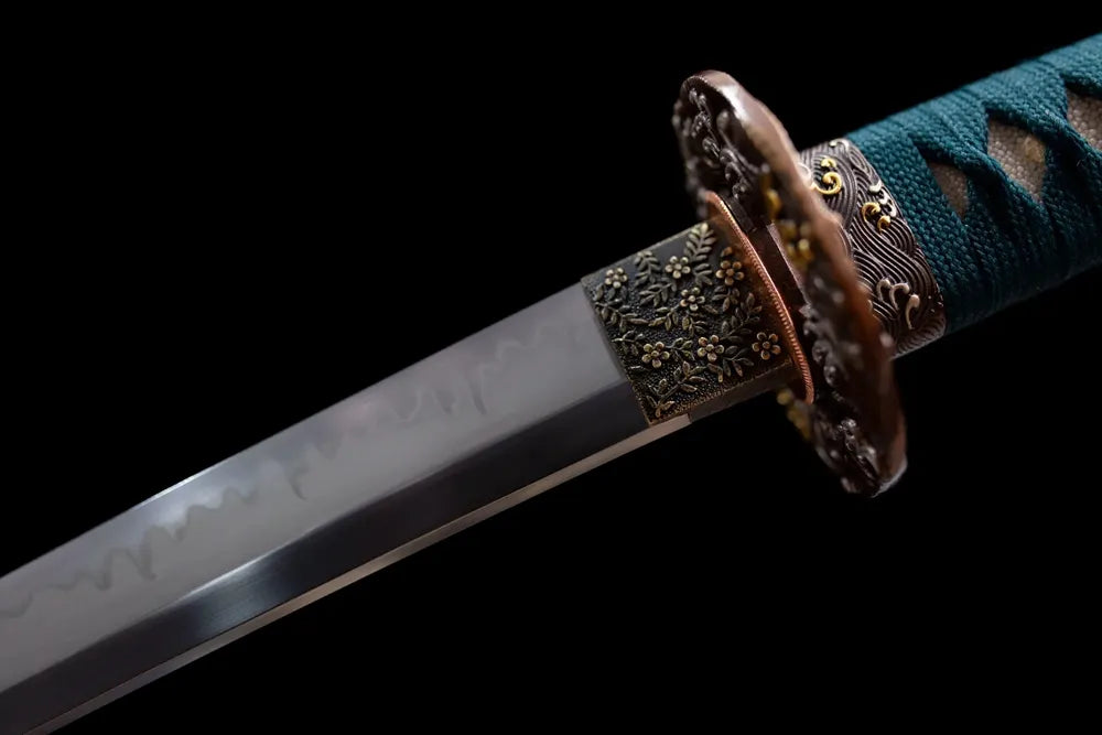 Upper T10 clay‑tempered wakizashi blade brass habaki natural hamon temper‑line macro close‑up