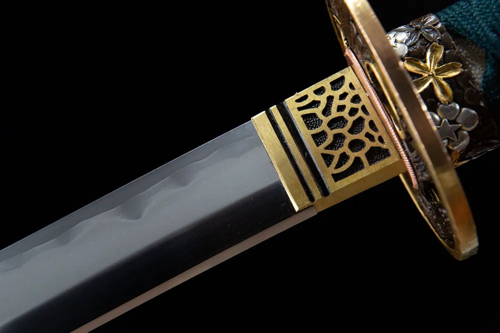 Upper blade closeup soft cloud notare hamon near gilded brass habaki