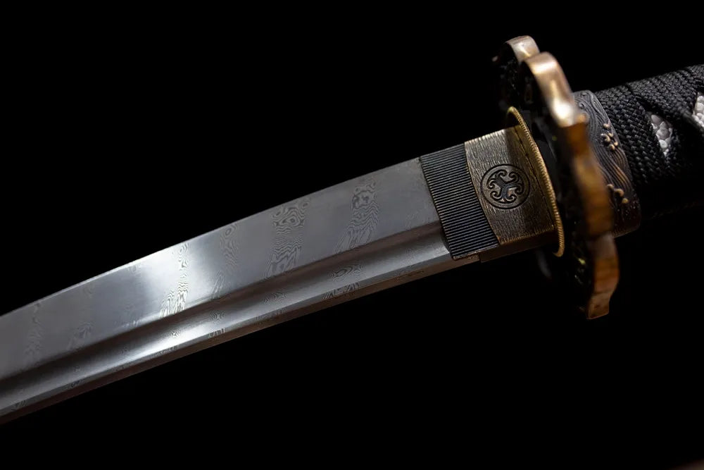 Upper T10 clay‑tempered wakizashi blade brass habaki natural hamon temper‑line macro close‑up