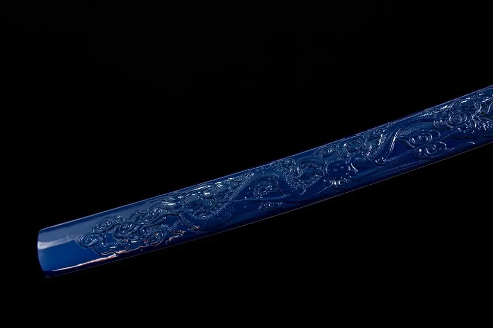 Bottom deep‑indigo‑blue saya antique‑gilt‑bronze kojiri end‑cap close‑up