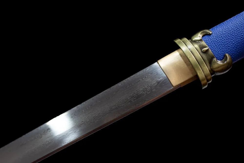 Upper folded damascus grain blade bronze habaki close-up