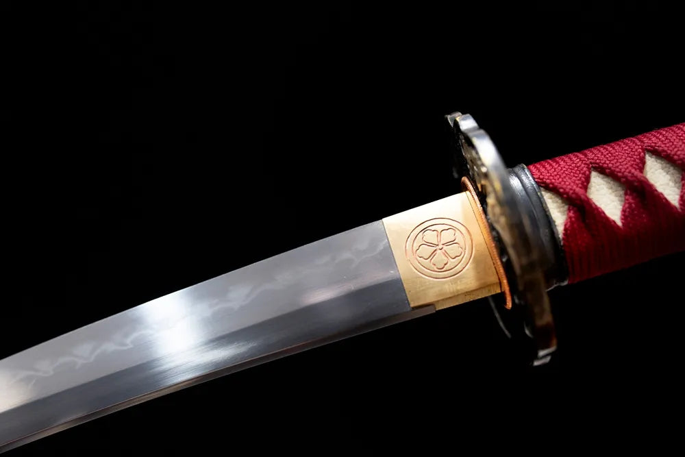 Upper T10 clay‑tempered wakizashi blade brass habaki clean suguha straight hamon temper‑line macro close‑up