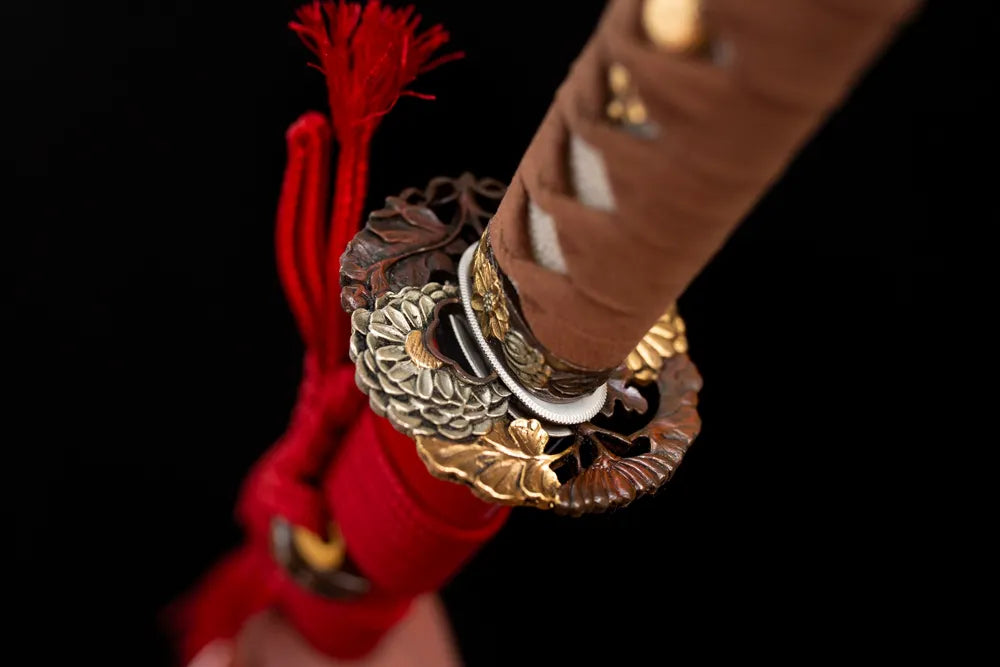 Reverse‑side sunflower‑bloom‑scroll carving brass‑gilded tsuba surface texture close‑up