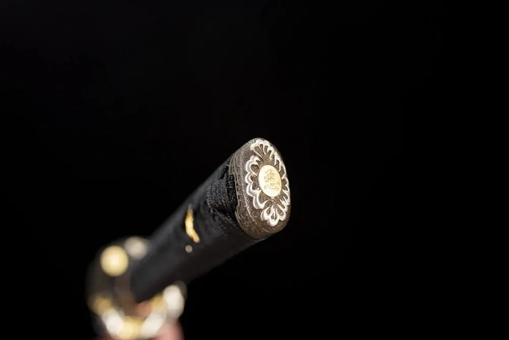 3D‑sculpted raijin‑thunder‑god‑emblem two‑tone aged‑copper pommel‑cap detail shot
