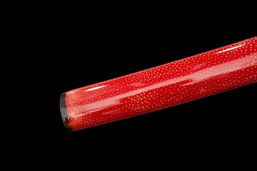 Bottom scarlet‑red saya antique‑copper kojiri end‑cap close‑up