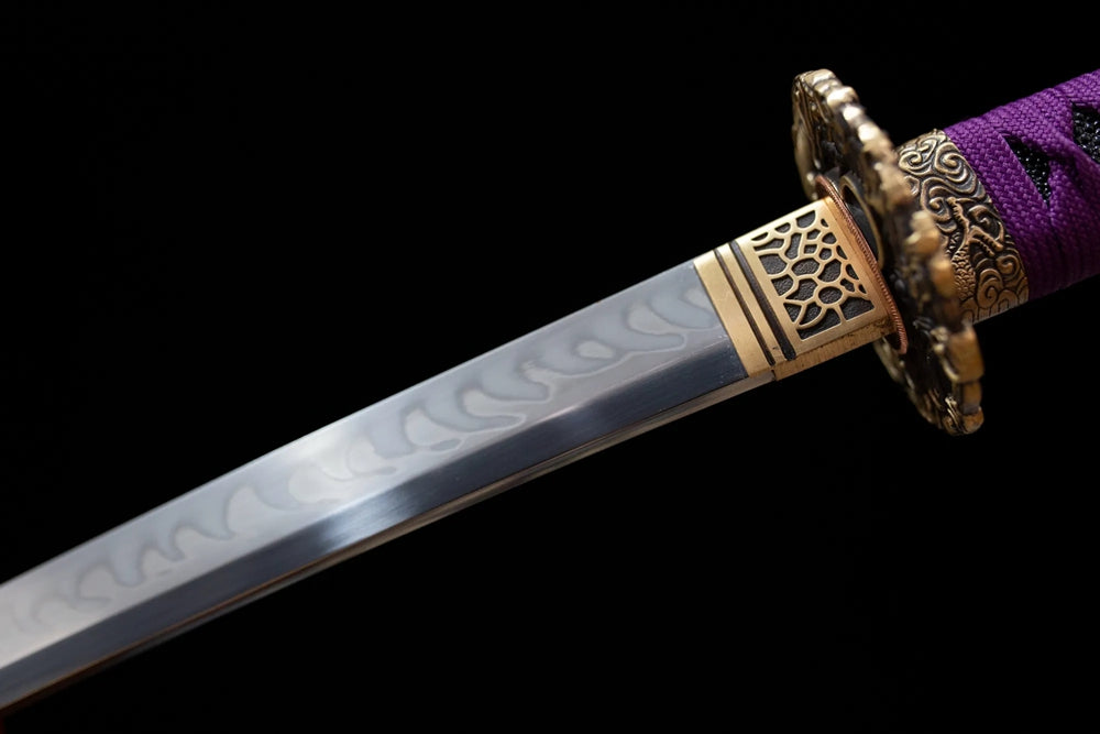 Upper T10 clay‑tempered katana blade brass habaki suguha‑gunome blended hamon temper‑line macro close‑up