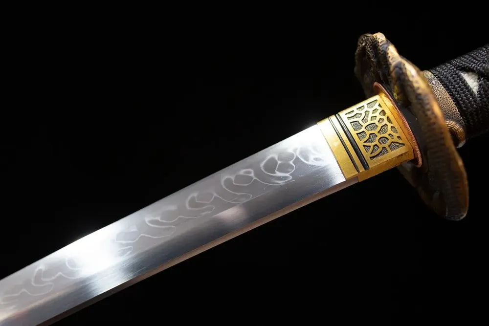 Upper T10 clay‑tempered katana blade brass habaki midare‑varied snake‑scale undulating hamon temper‑line macro close‑up