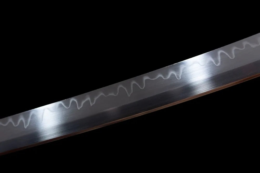 Mid‑section distinctive sanbonsugi three‑peak hamon steel katana blade surface close‑up shot