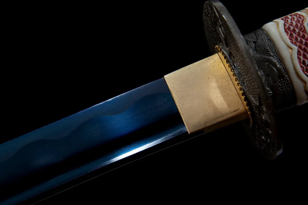 Upper blade closeup full mirror blue polished T10 smooth surface near golden habaki