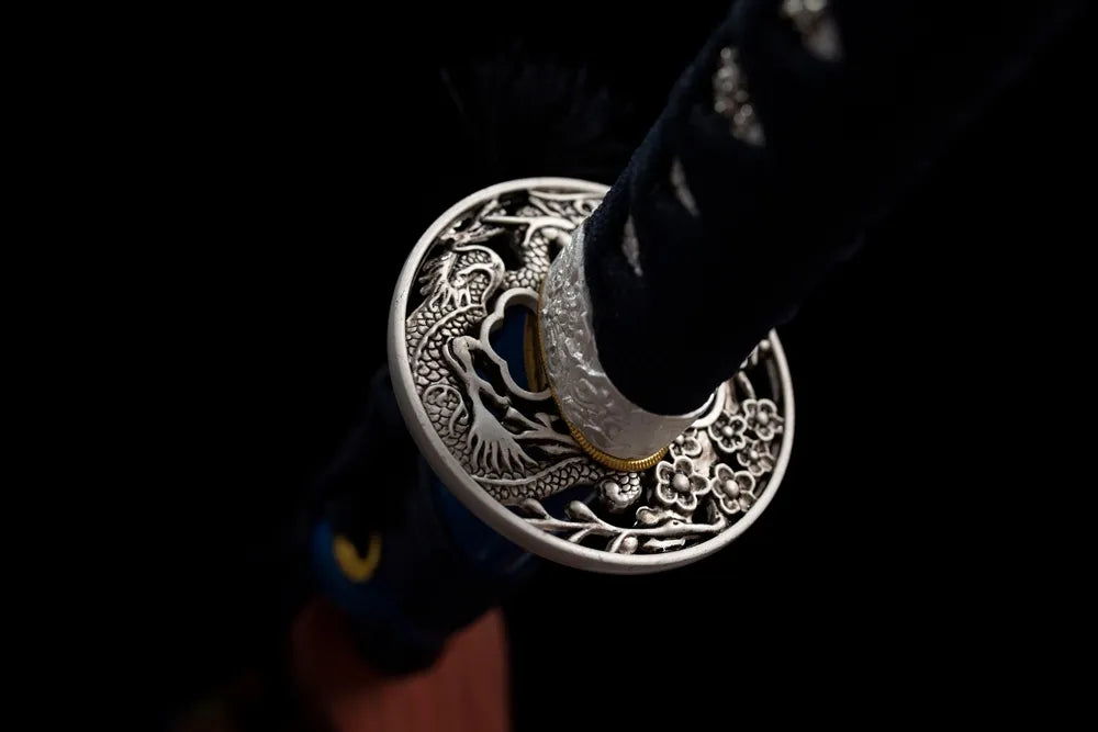 Reverse side dragon‑plum‑blossom hollow carving alloy tsuba surface texture close‑up