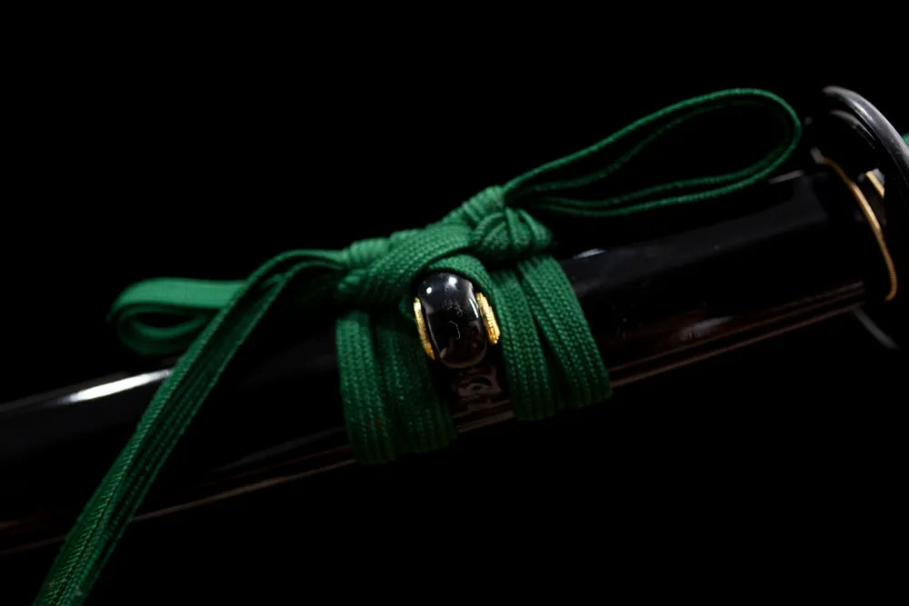 Thick forest‑green mixed‑braided sageo cord aged‑alloy fitting macro close‑up