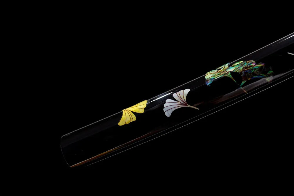 Bottom ivory ginkgo‑print saya brass‑toned alloy end‑cap close‑up