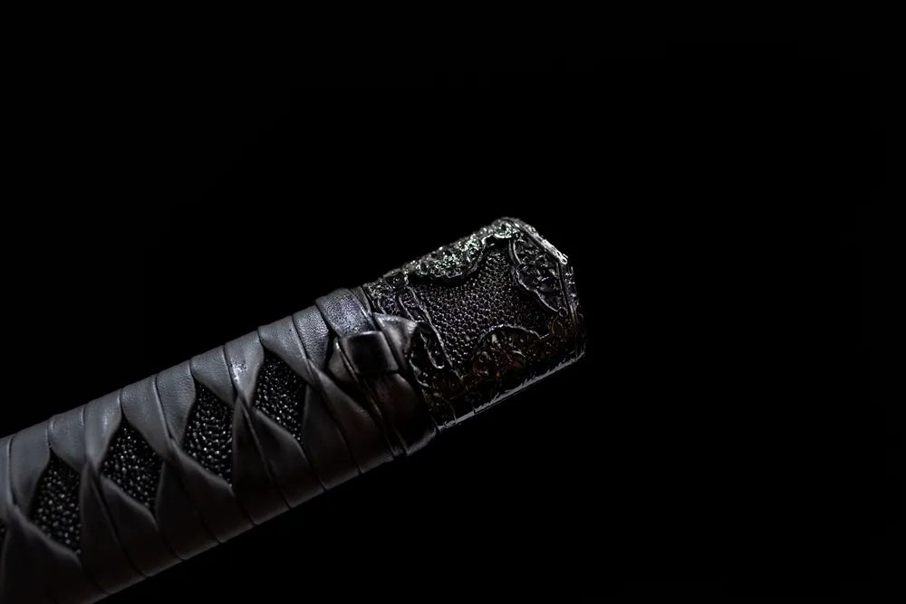 3D carved black pommel cap close detail