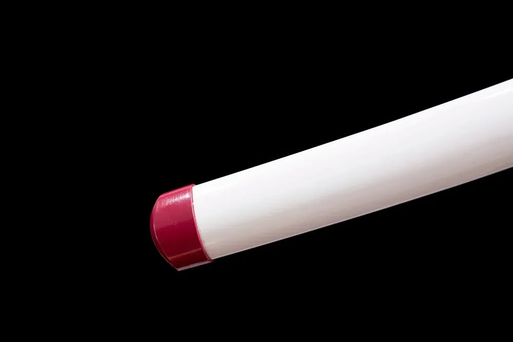 Bottom glossy white saya magenta‑red alloy end‑cap close‑up