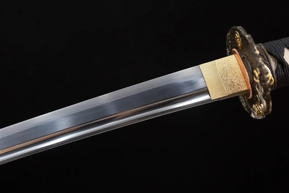 Upper T10 clay‑tempered katana blade brass habaki suguha‑straight clean hamon temper‑line macro close‑up