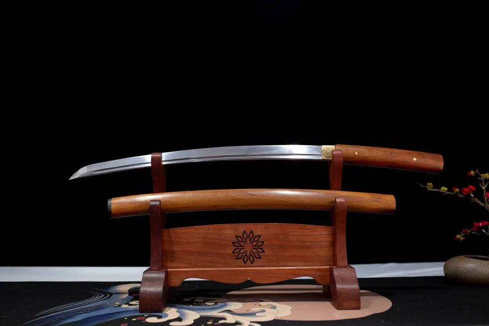 Flat fully‑drawn T10 clay‑tempered notare‑gunome‑hamon Jihad‑Shirasaya‑Wakizashi blade wooden rack front shot