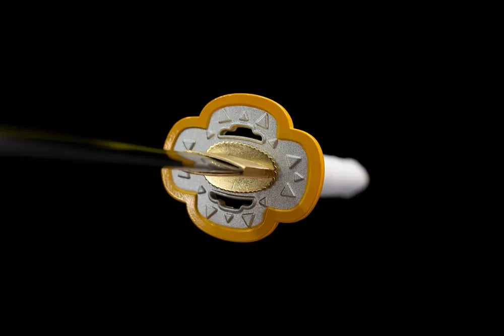 Front flower‑shape golden‑trim zinc‑alloy thunder‑breathing demon‑slayer hand‑guard close‑up
