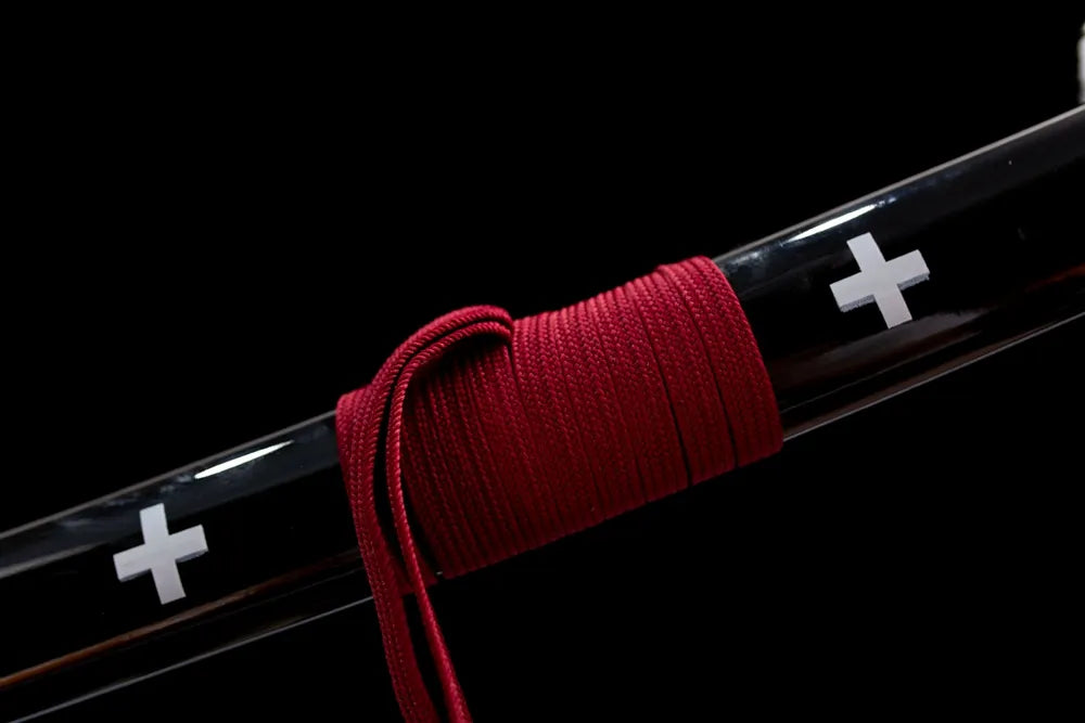 Mid‑section glossy black hardwood saya white heart‑pirate cross print texture