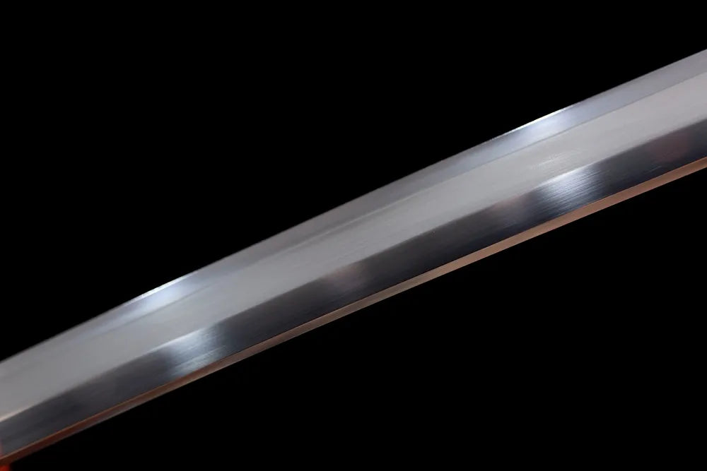 Mid‑section freehand ink‑cloud decorative etched steel blade surface close‑up shot
