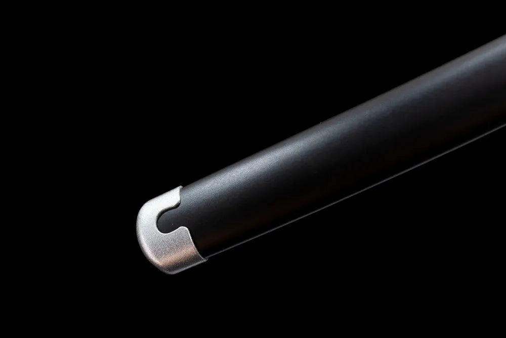 Lower section of black lacquered saya with metal kojiri end cap close‑up