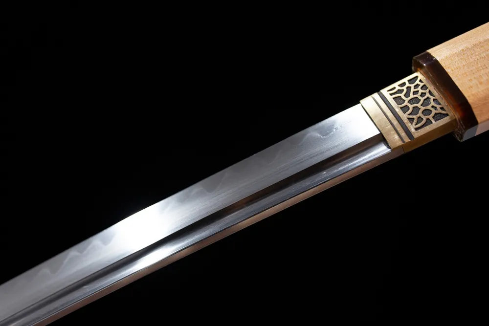Upper T10 clay‑tempered katana blade brass habaki clean suguha plain‑straight hamon temper‑line macro close‑up