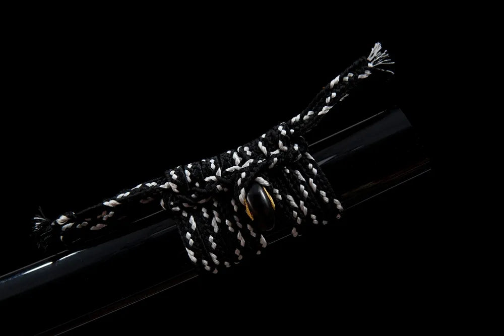 Thin black cotton sageo cord tied on dark wood saya ring