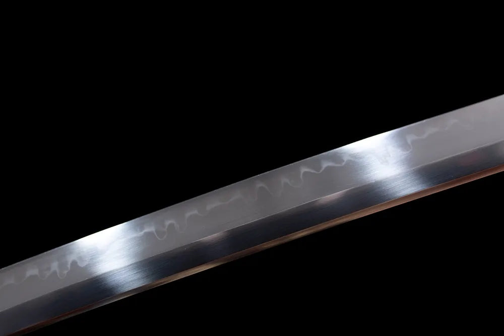 Mid‑section natural uneven hamon steel katana blade surface close‑up shot