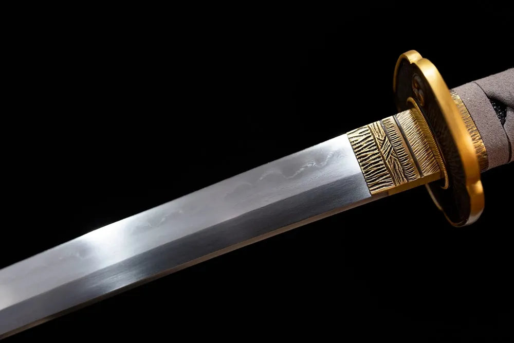Upper T10 clay‑tempered katana blade brass habaki clean suguha plain‑straight hamon temper‑line macro close‑up