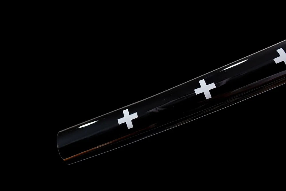 Bottom black lacquer saya golden‑alloy end‑cap close‑up