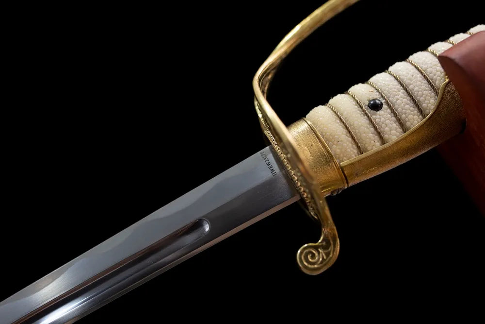 Upper T10A clay‑tempered saber blade brass bolster notare hamon temper‑line macro close‑up