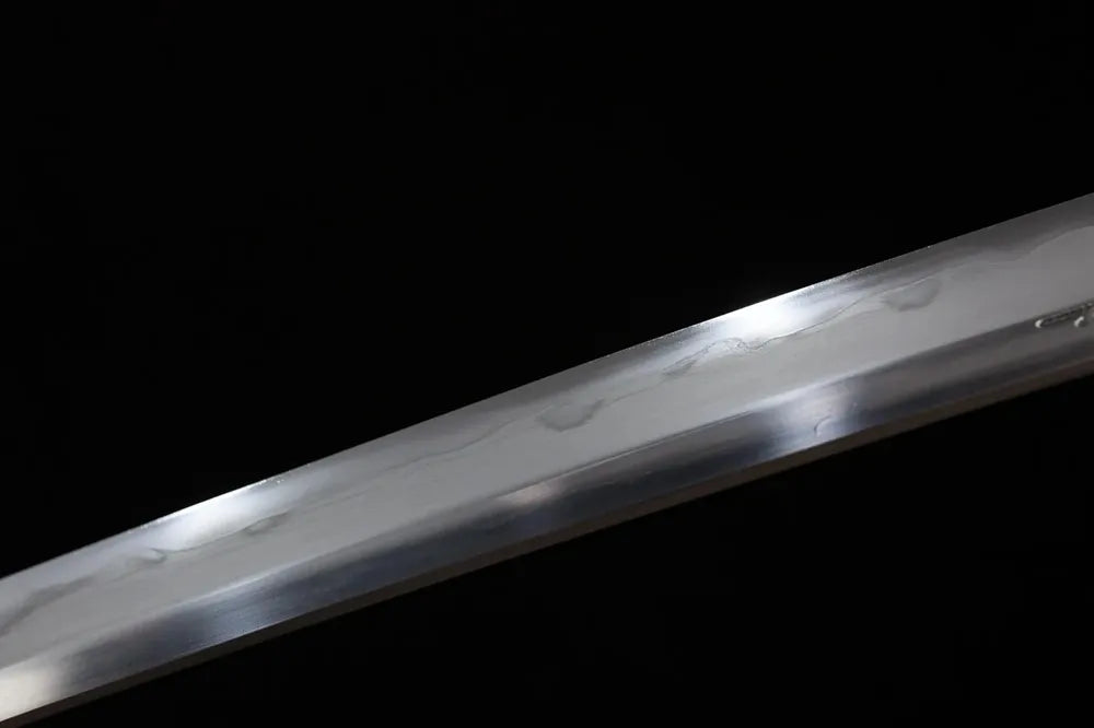 Mid‑section gunome undulating wave‑pattern hamon composite‑steel tachi blade surface close‑up shot