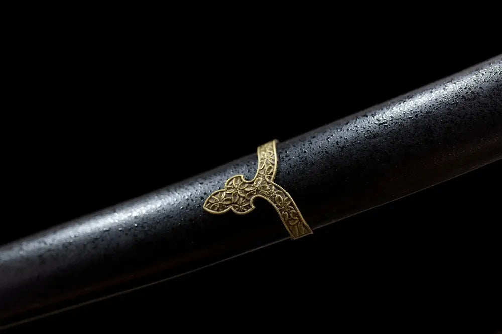 Mid‑section full matte‑black lacquer hardwood tachi saya smooth pattern‑free plain surface close‑up