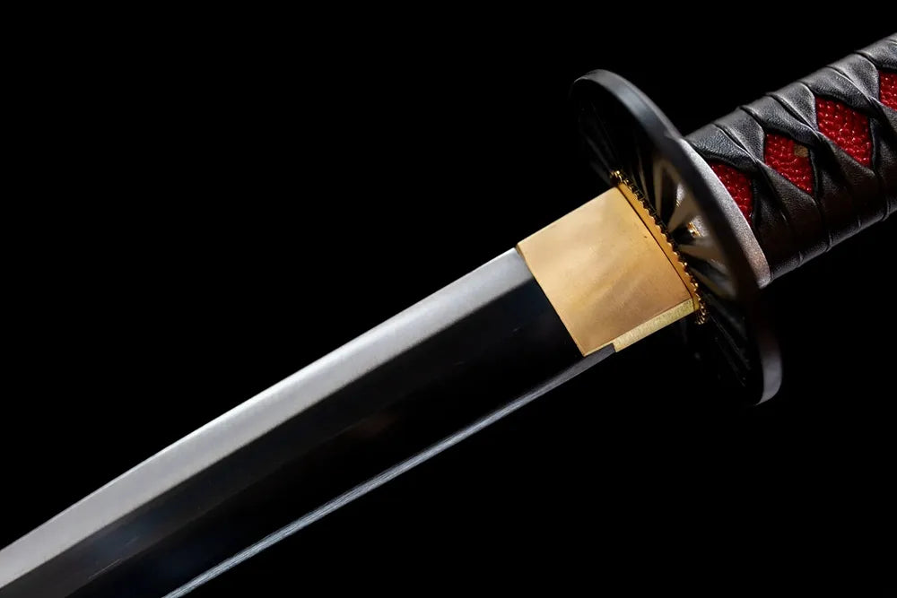 Upper section of black nichirin steel blade together with habaki macro close‑up