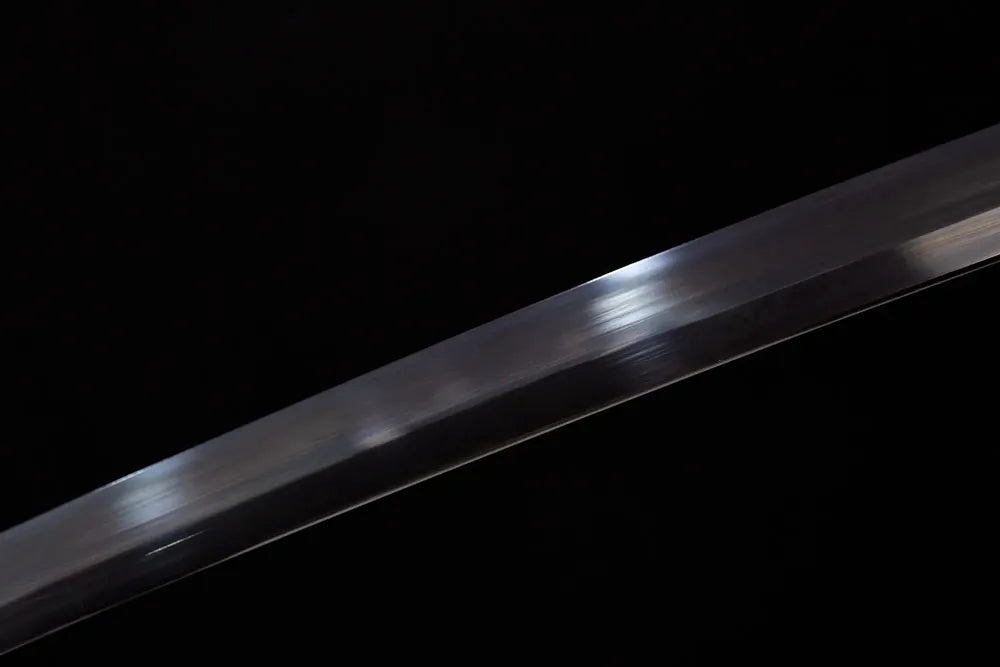 Mid‑section solid‑black‑oxide matte‑black steel katana blade surface close‑up shot