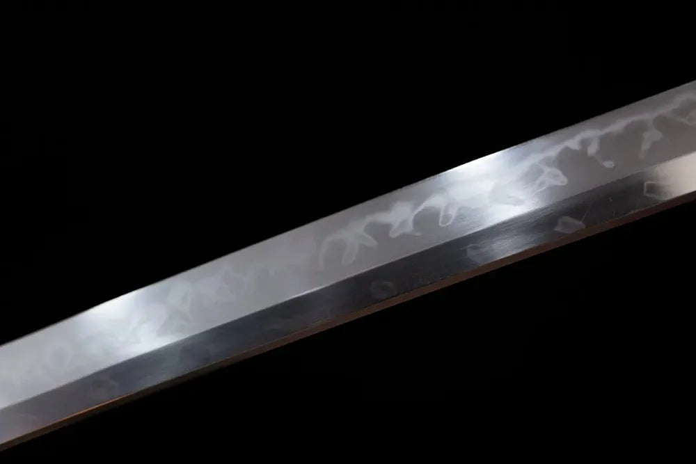 Mid‑section hitatasura dragon‑claw‑tearing‑pattern hamon steel katana blade surface close‑up shot