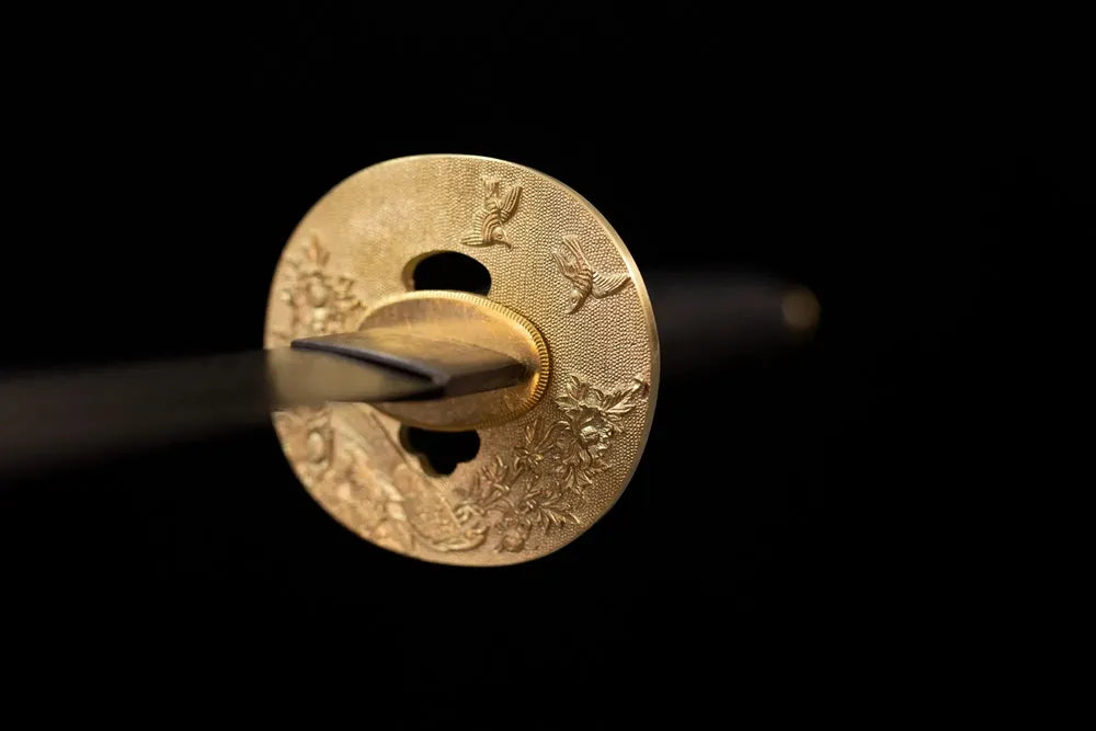 Front open‑work bird‑plumage‑wing‑relief vintage‑bronze katana hand‑guard close‑up