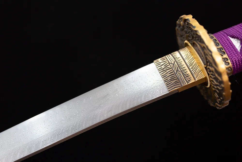 Upper damascus oil‑quenched katana blade brass habaki natural‑flow layered‑stream hamon temper‑line macro close‑up