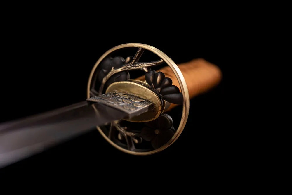 Front open‑work plum‑blossom carved brass‑alloy wakizashi hand‑guard close‑up