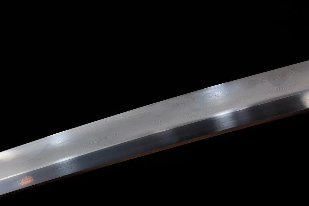 Mid‑section gunome undulating‑wave‑pattern hamon composite‑steel katana blade surface close‑up shot