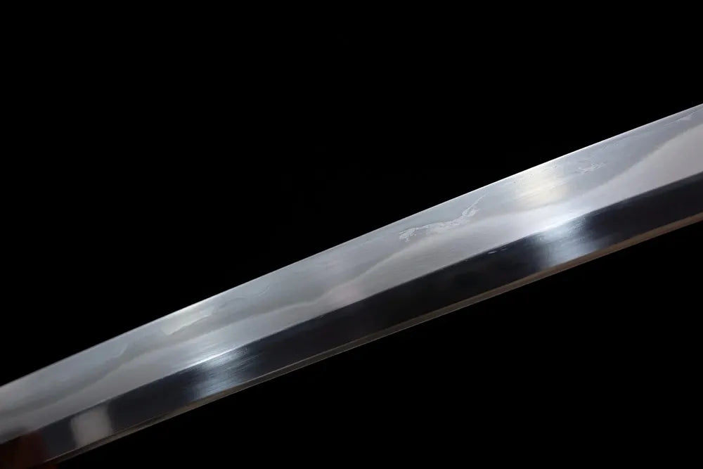 Mid‑section suguha‑midare moon‑wave‑shifting‑pattern hamon steel katana blade surface close‑up shot