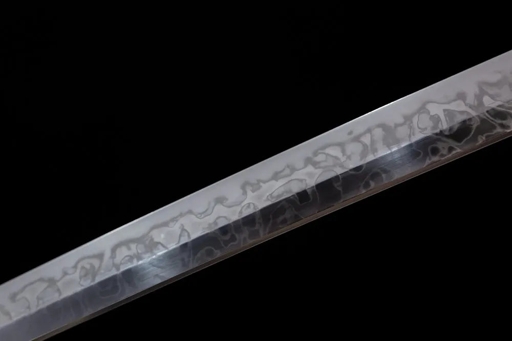 Mid‑section suguha‑midare ink‑diffusion‑flowing‑pattern hamon steel katana blade surface close‑up shot