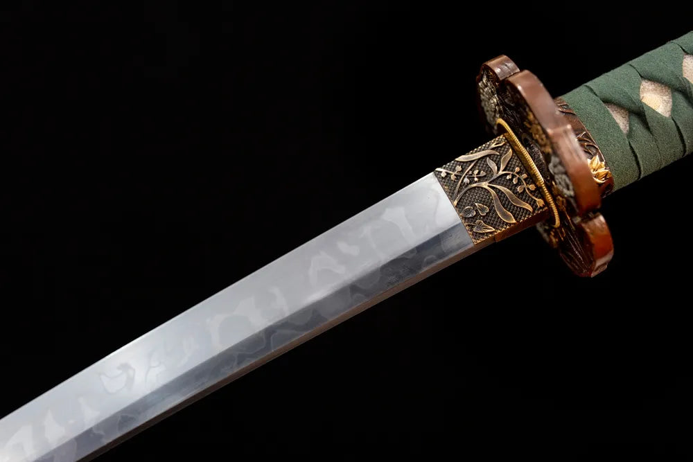 Upper T10 clay‑tempered katana blade brass habaki choji‑gunome bell‑ripple layered‑serrated hamon temper‑line macro close‑up