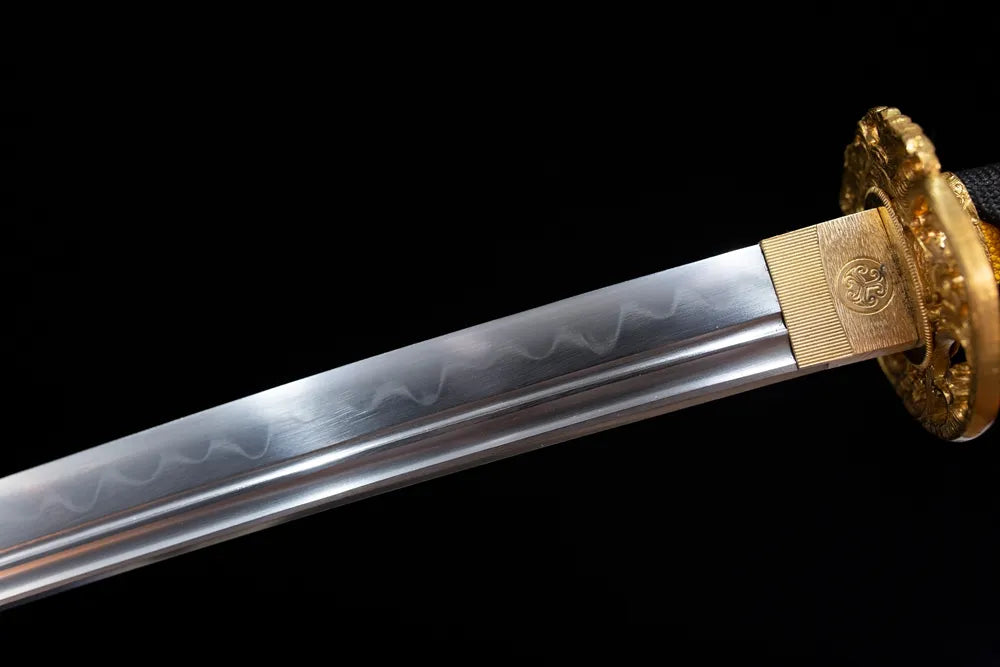 Upper T10 clay‑tempered katana blade brass habaki sanbonsugi three‑cedar‑tree flowing hamon temper‑line macro close‑up
