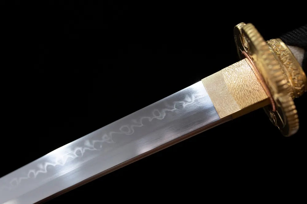 Upper T10 clay‑tempered katana blade brass habaki midare‑suguha night‑mist‑nebulous shifting hamon temper‑line macro close‑up