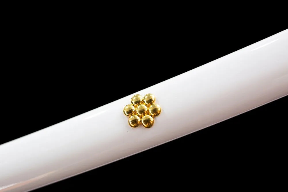 Mid‑section glossy white hardwood saya gold flower‑shaped rivet ornament texture