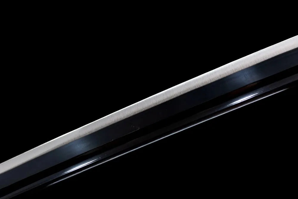 Mid‑section single blood‑groove steel blade engraved kanji surface texture shot